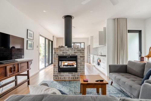 a living room with a couch and a fireplace at The Getaway - Galston in Galston