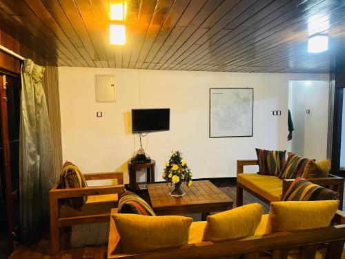 a living room with a couch and a table at Agarapathana Estate Holiday Bungalow in Hatton