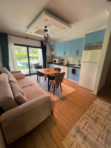 a living room with a couch and a table at Sea Life Homes in Kemer