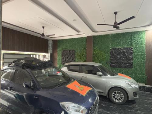 a couple of cars parked in a garage at Hotel Radha Madhavam Luxurious Boutique Stay in Mathura