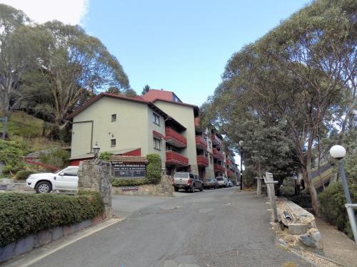 a building on the side of a street with cars parked at Mowamba D5 in Thredbo