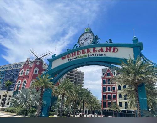a sign with a clock on top of a building at Ho tram Beach Villa Biển Xuyên Mộc in Xuyên Mộc