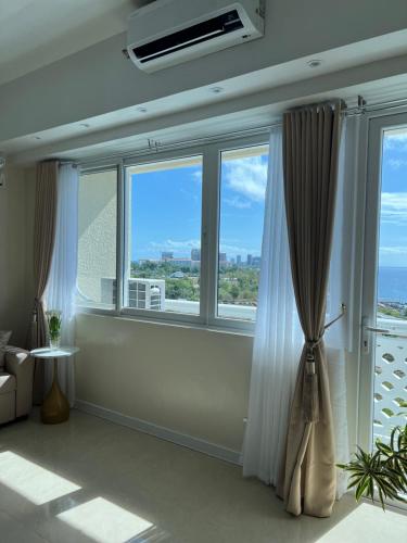 a room with a large window with a view of the ocean at La Mirada Residences Sea-view Suites in Mactan
