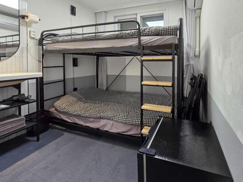 a room with two bunk beds and a desk at AccessHouse in Seoul