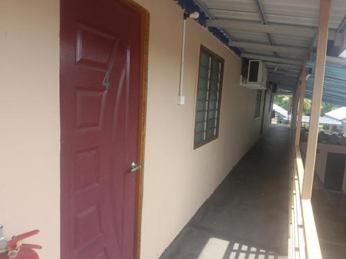 an open door of a house with a hallway at Dalya's Roomstay in Tanjung Karang