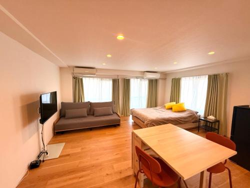 a living room with a bed and a couch at home Shinjuku west302 in Tokyo