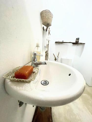 a bathroom sink with a soap in a basket at Habitación 6 personas in Moñitos
