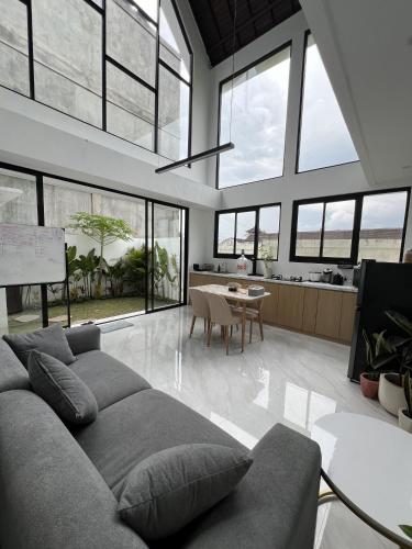 a living room with a couch and a table at Villa Tres Adam in Canggu