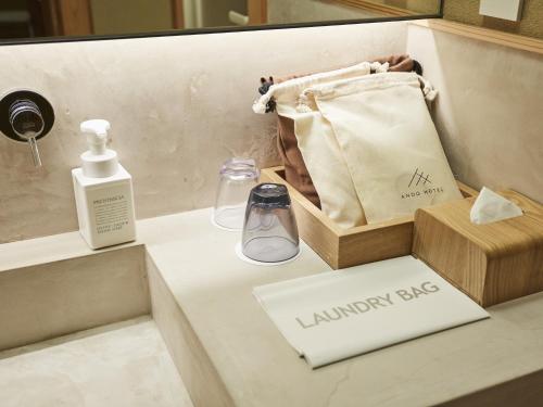 a bathroom with a perfume bottle and a box at ANDO HOTEL NARA Wakakusayama -DLIGHT LIFE & HOTELS- in Nara