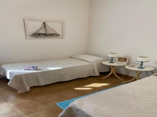 A bed or beds in a room at Apartment in Porto Pollo near Surf Paradise