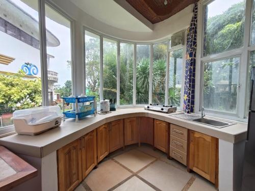 a kitchen with a sink and a large window at Casa de Arte in Boracay