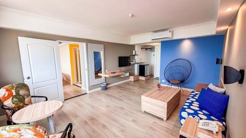 a living room with a couch and a table at Hua Hin Grand Hotel and Plaza - SHA Extra Plus in Hua Hin