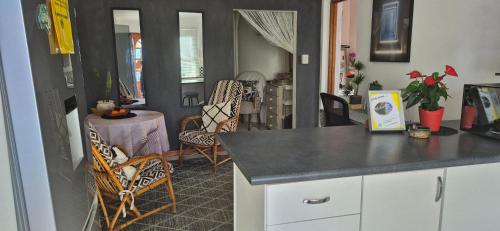 a kitchen with a table and chairs in a room at At lilac, Jeffreys Bay, cottage for 2 in Jeffreys Bay