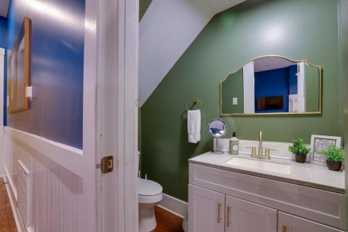 a bathroom with a sink and a mirror at Mid-Century getaway in Savannah