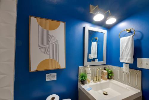 a bathroom with a sink and a blue wall at Mid-Century getaway in Savannah