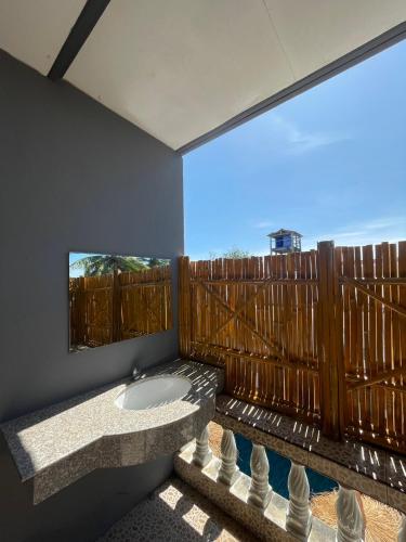 a bathroom with a sink and a large window at Lanta Corsica Hostel in Ko Lanta Yai