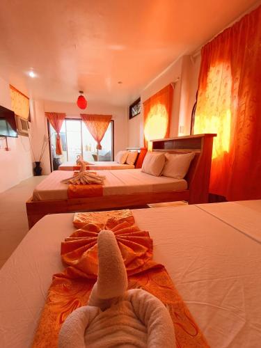 a hotel room with two beds with towels on them at Casa de Arte in Boracay