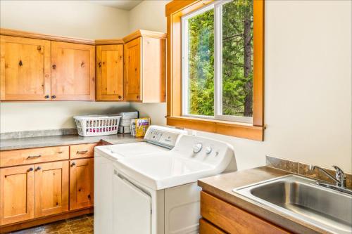 a kitchen with a white dishwasher next to a sink at White Water Lodge in Leavenworth