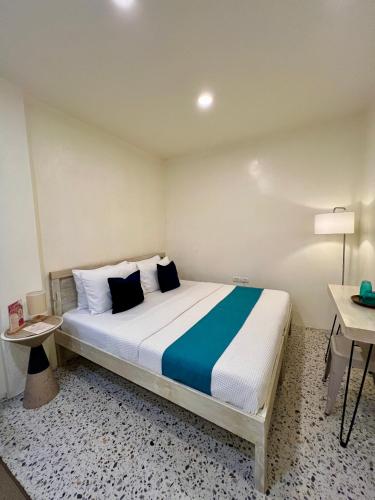 a bedroom with a large bed in a room at BIG WAVES BOUTIQUE HOTEL SIARGAO in General Luna