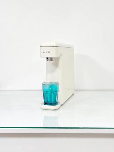 a laboratory microscope with a blue glass on a counter at HeiStay-30sec from Hongdae SubwayStop-Elevator in Seoul