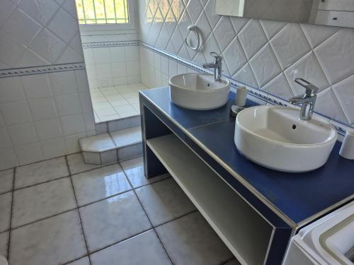 une salle de bains avec deux lavabos sur un comptoir bleu dans l'établissement Appartement dans mas catalan avec climatisation et WiFi - FR-1-776-127, à Argelès-sur-Mer