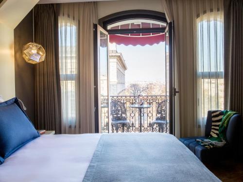 a bedroom with a large bed and a large window at Maroon Hotel Pera in Istanbul