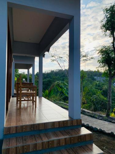 a view from the front porch of a house at Tommy Homestay in Plambi