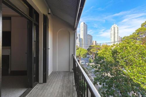a balcony of a building with a view of a city at The Victorian Stone Terrace in Sydney