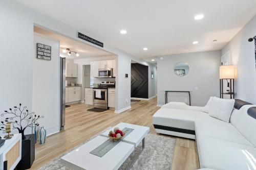 a living room with a white couch and a table at Home away from Home in Hampton