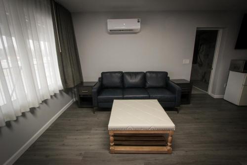 a living room with a couch and a table at Envi Boutique Hotel Henderson-Evansville South in Henderson