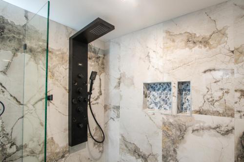 a shower with a glass door in a bathroom at Envi Boutique Hotel Henderson-Evansville South in Henderson