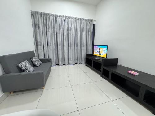 a living room with a couch and a television at Cheras Trader Park By JR in Cheras