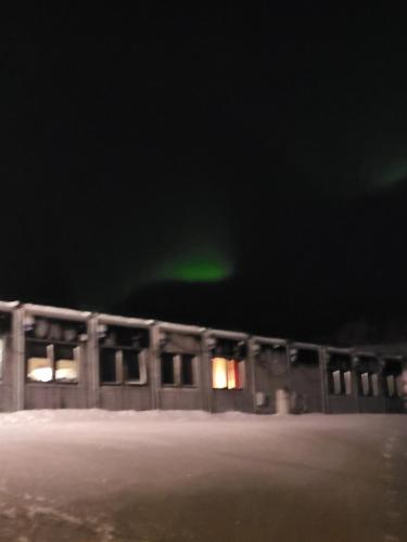 a building with a green light in the dark at Odd inge Sør-Reime as in Nesseby