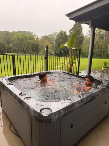 two men in a jacuzzi in at Lumeah by the Creek in Whian Whian