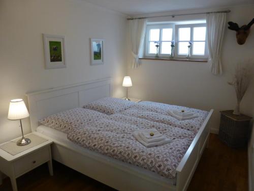 a bedroom with a bed with two towels on it at Apartment Schreyegg in Seefeld