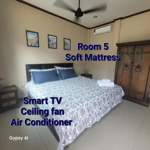 a bedroom with a bed and a ceiling fan at TW Resort - Adults Only in Nong Prue