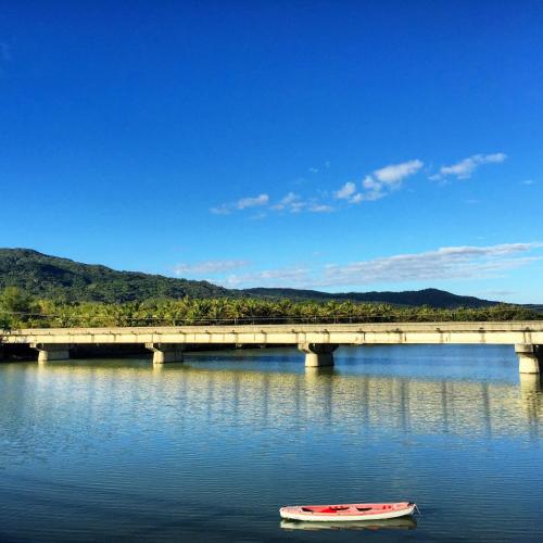 a boat in the water next to a bridge at Doll House Lodge in Hengchun
