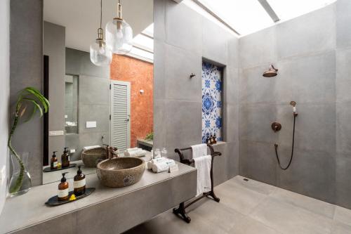 a bathroom with a sink and a shower at La Zamora, 3BHK Villas near Vagator & Anjuna Beach, North Goa with Private Pool, Garden, Terrace & Security in Assagao