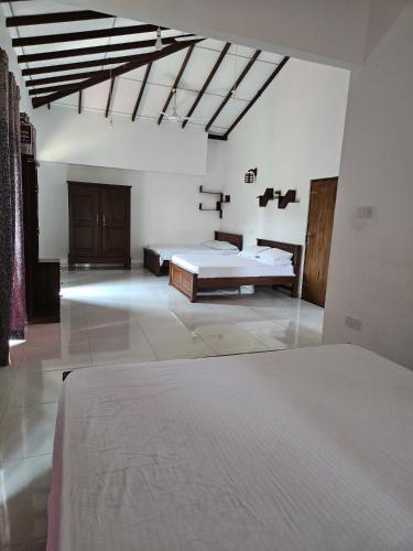 a bedroom with two beds in a room at Temuri Resort in Hambantota