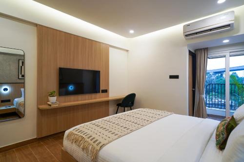 Olive Hotel Mahadevapura by Embassy Groupにあるテレビまたはエンターテインメントセンター