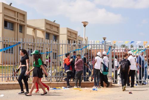 a group of people walking in front of a fence at Like Home Gedera in Gedera