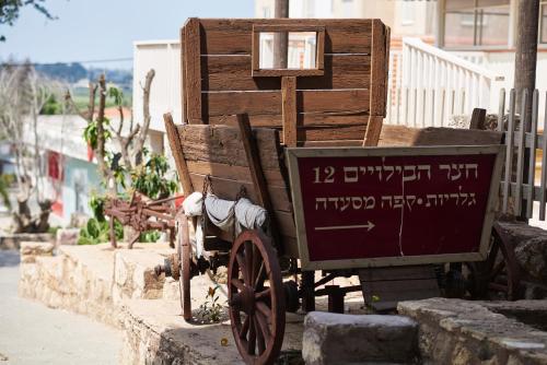 a wooden cart sitting on the side of a street at Like Home Gedera in Gedera