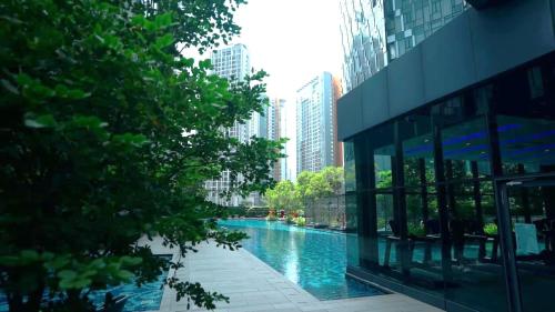 a building with a swimming pool in a city at Star Residences KLCC in Kuala Lumpur
