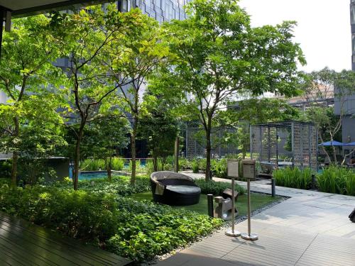 a garden with a bench and trees and a building at Star Residences KLCC in Kuala Lumpur