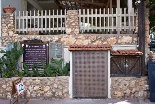 a building with a gate and a sign on it at Like Home Gedera in Gedera
