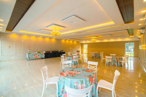 a banquet hall with a table and chairs in a room at Treebo Greenland Resort Patia in Bhubaneshwar