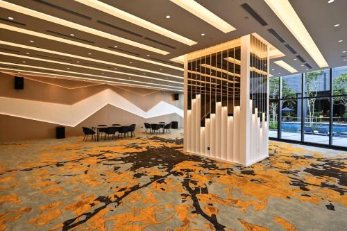 a lobby with chairs and tables in a building at Star Residences KLCC in Kuala Lumpur