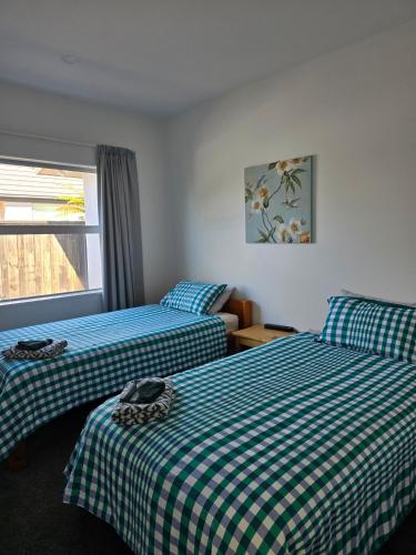 a room with two beds and a window at Pegasus Golf course Awaiting in Woodend