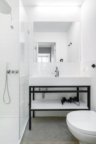 a white bathroom with a sink and a toilet at WHome | LS48 Prime Location Upscale Family Apartment in Lisbon