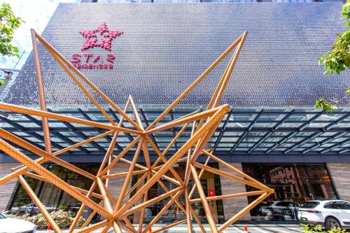 a large wooden sculpture in front of a building at Star Residences KLCC in Kuala Lumpur